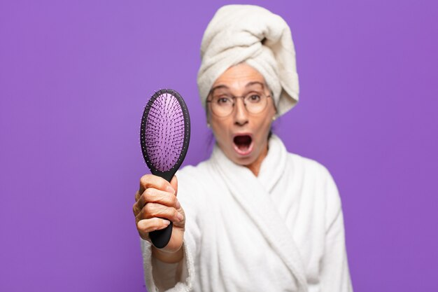 Person using microfiber towel to dry wet hair gently